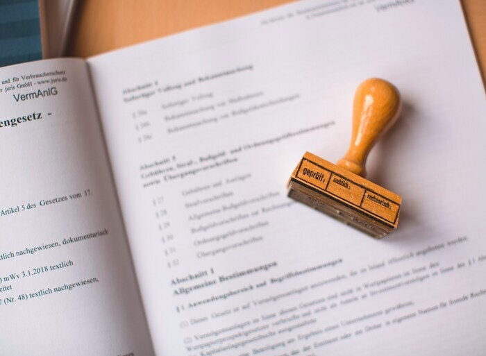Person verifying ID and document with a stamp